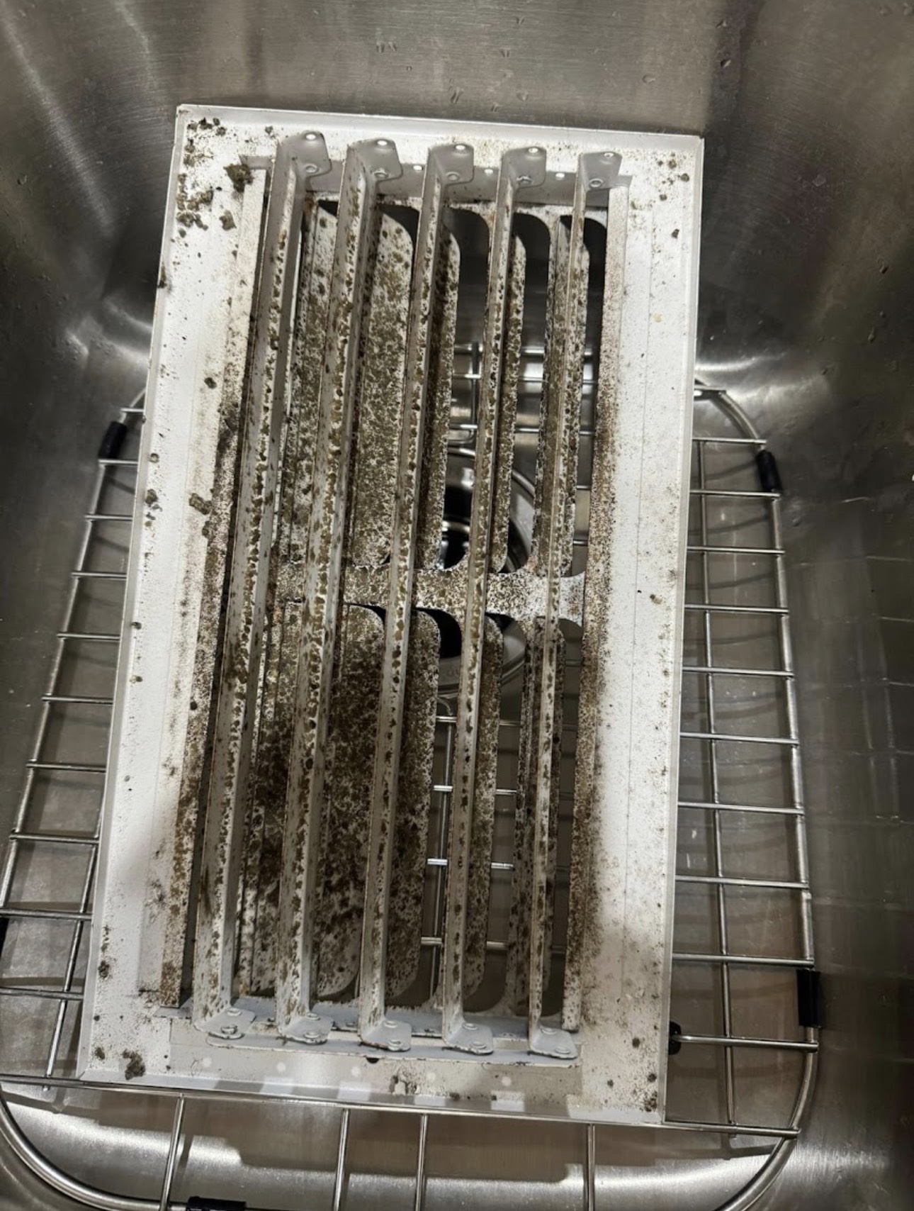 Dust-caked return air grille removed before any cleaning, Brandon FL